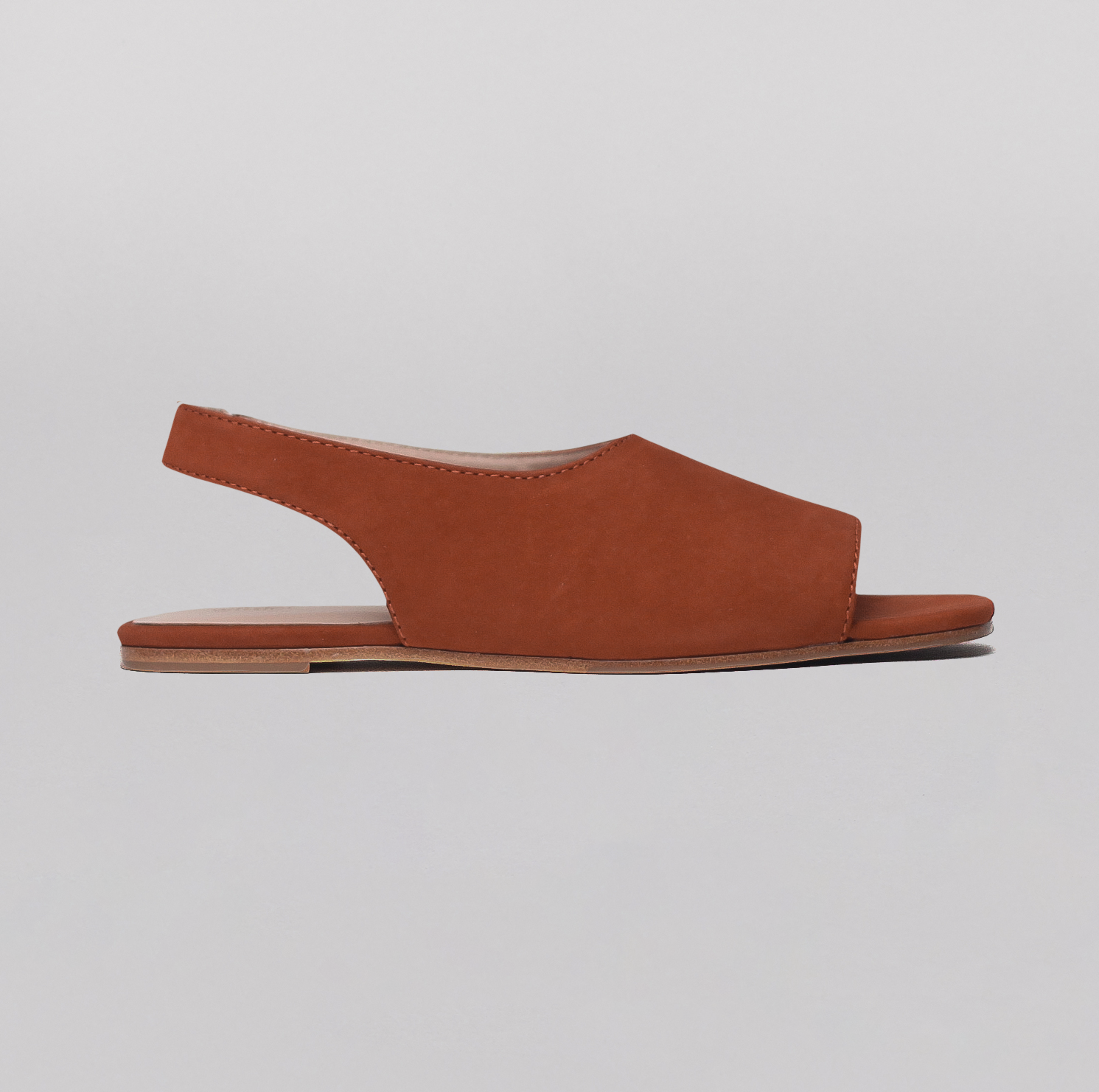 profile view of women's flat sandal in brown leather